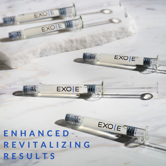 A series of glass vials labeled EXO with a blue cap on a marble background, with text stating 'ENHANCED REVITALIZING RESULTS'.
