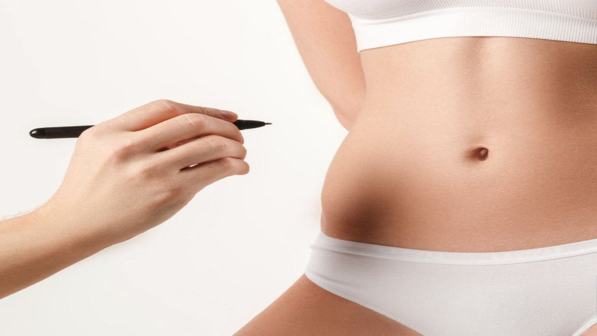 A person undergoes a skin tightening procedure with a handheld device, focusing on a targeted area of the abdomen.